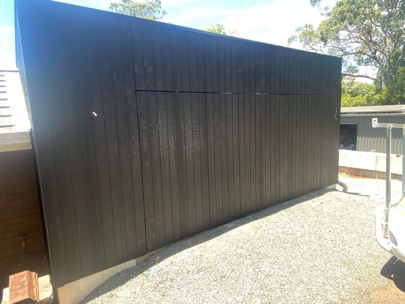 after Wood-look Galvanised Steel Frame + Dark Weathertex Cladding Tilt Door – Tilt (Mitch Hill Building), East Toowoomba