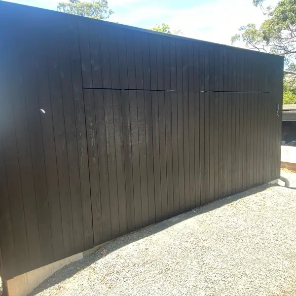 after Wood-look Galvanised Steel Frame + Dark Weathertex Cladding Tilt Door – Tilt (Mitch Hill Building), East Toowoomba