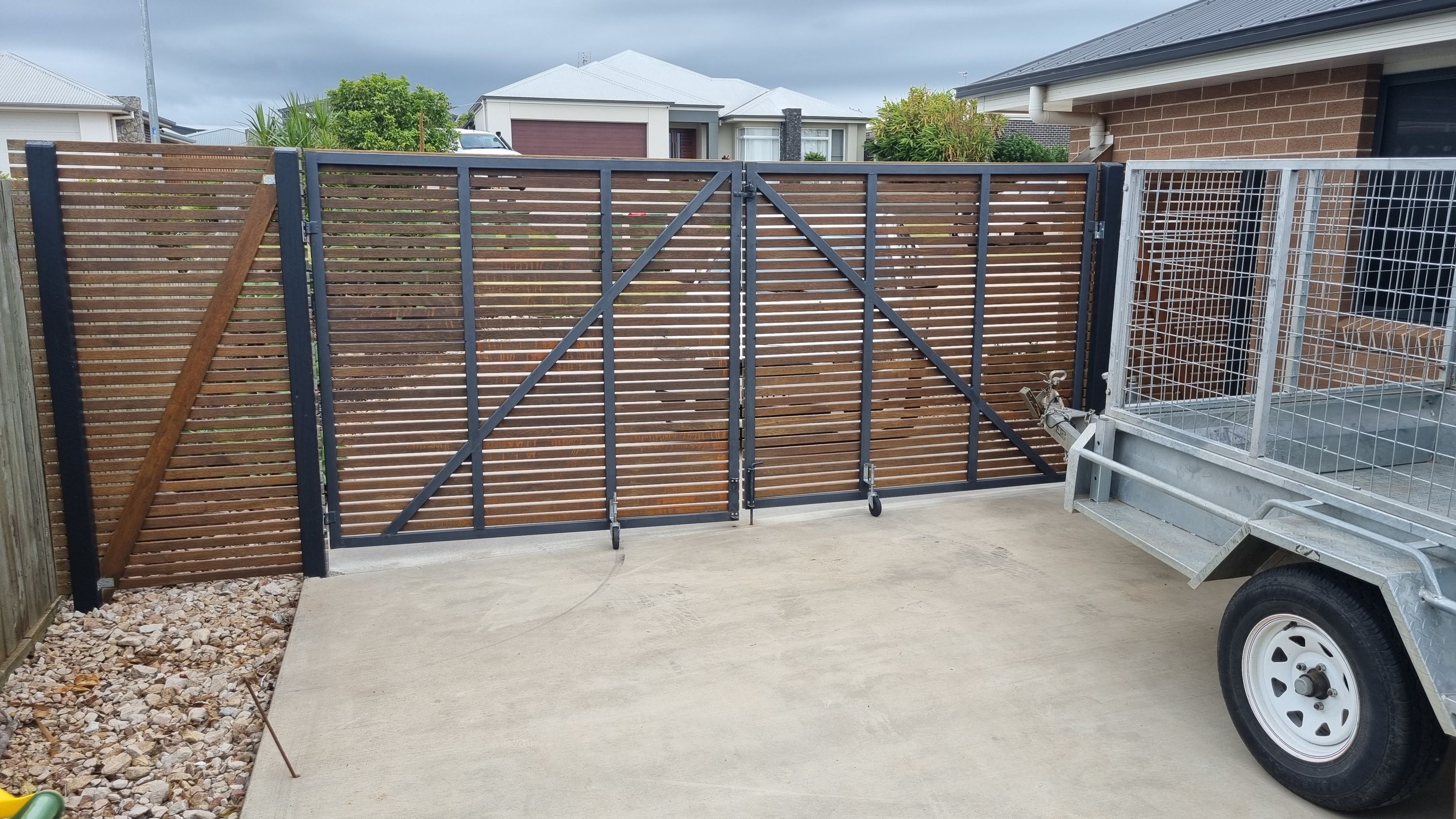 after Wood-look + Black Timber + Powder-coated Steel Sliding Gate – Gate Fabrication, Highfields