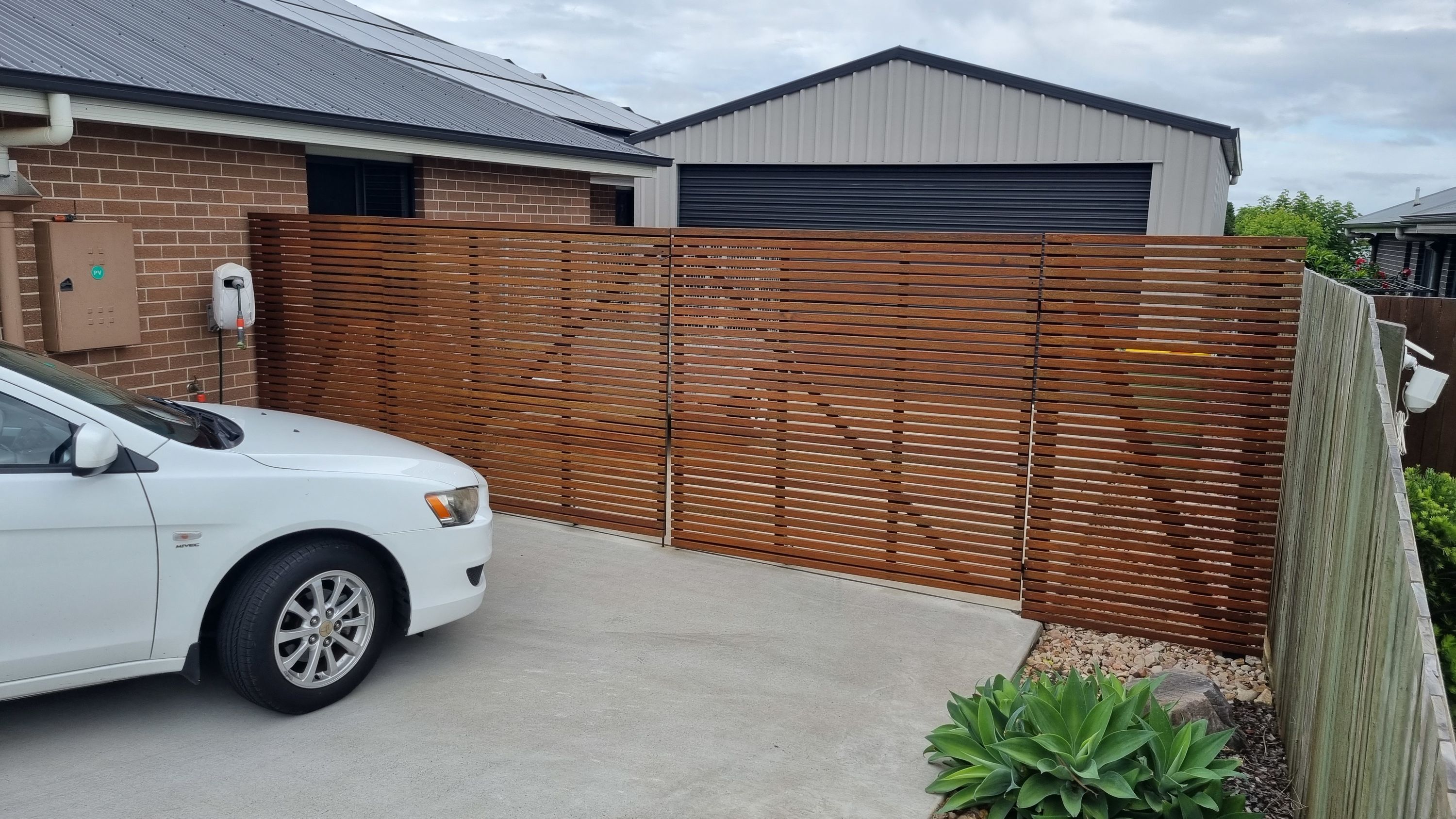 after Wood-look + Black Timber + Powder-coated Steel Sliding Gate – Gate Fabrication, Highfields