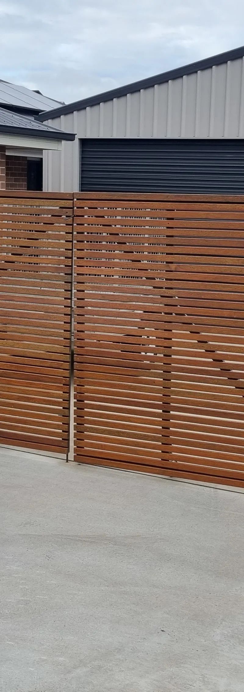 after Wood-look + Black Timber + Powder-coated Steel Sliding Gate – Gate Fabrication, Highfields