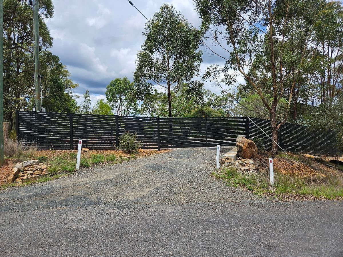 after Monument Colorbond Steel Sliding Gate – Slide Gate + Motor (Monument 1800x5000 Horizontal Slat + Infill Panels + LV Motor + Steel Return), Cabarlah