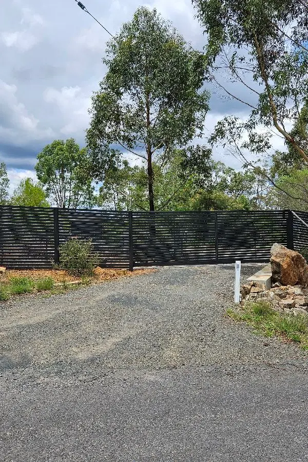 after Monument Colorbond Steel Sliding Gate – Slide Gate + Motor (Monument 1800x5000 Horizontal Slat + Infill Panels + LV Motor + Steel Return), Cabarlah