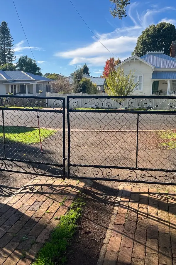 before Black Wrought Iron Swing Gate – Bar Grille + Motor, Newtown